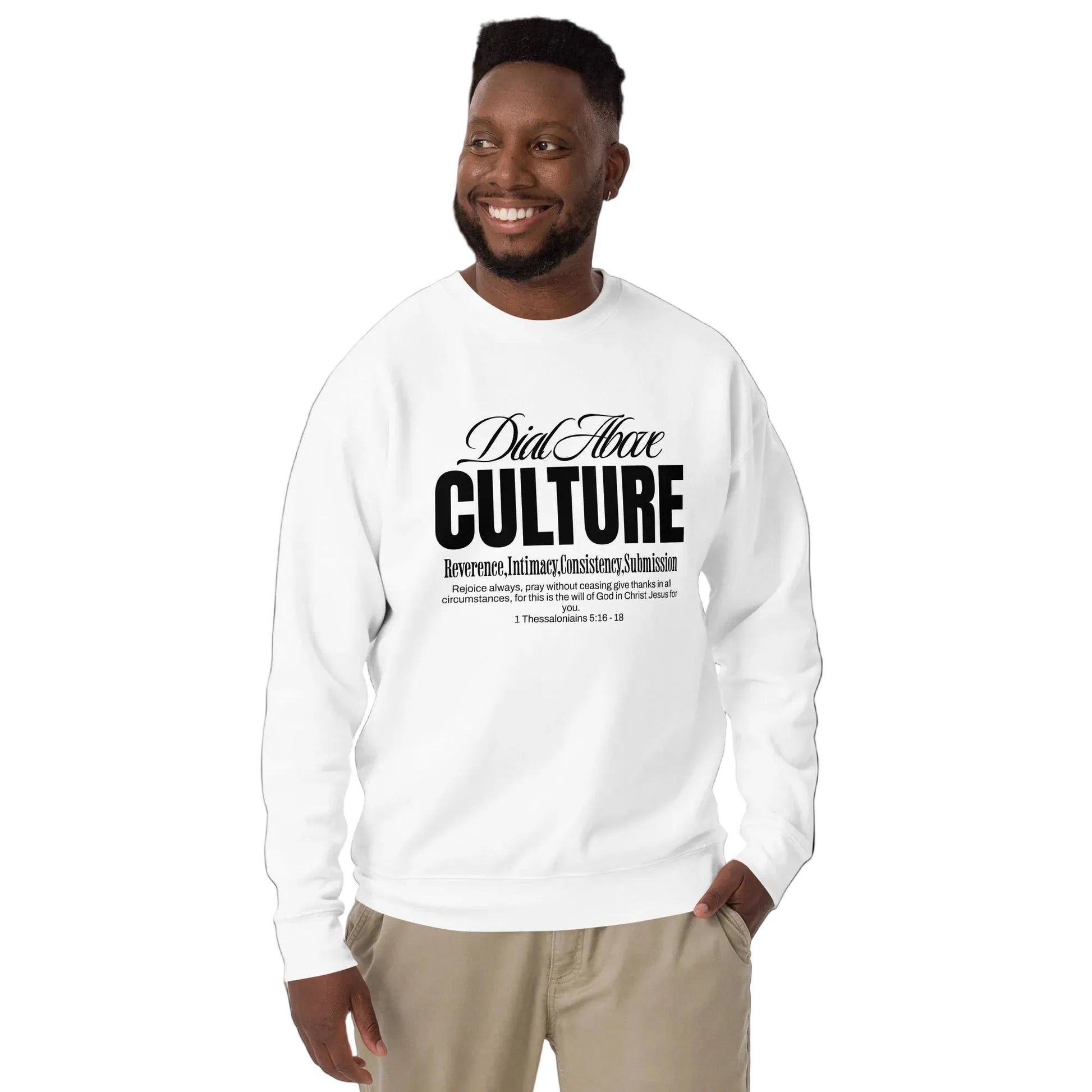 Man wearing a white sweatshirt with text Dial above culture-prayer on a plain background
