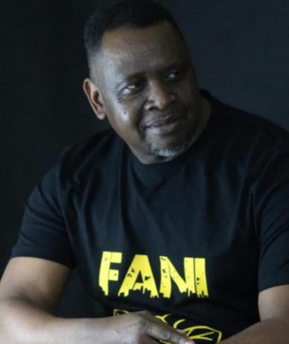 Fani wearing a black t-shirt inspired by Dial Above Prayer designs