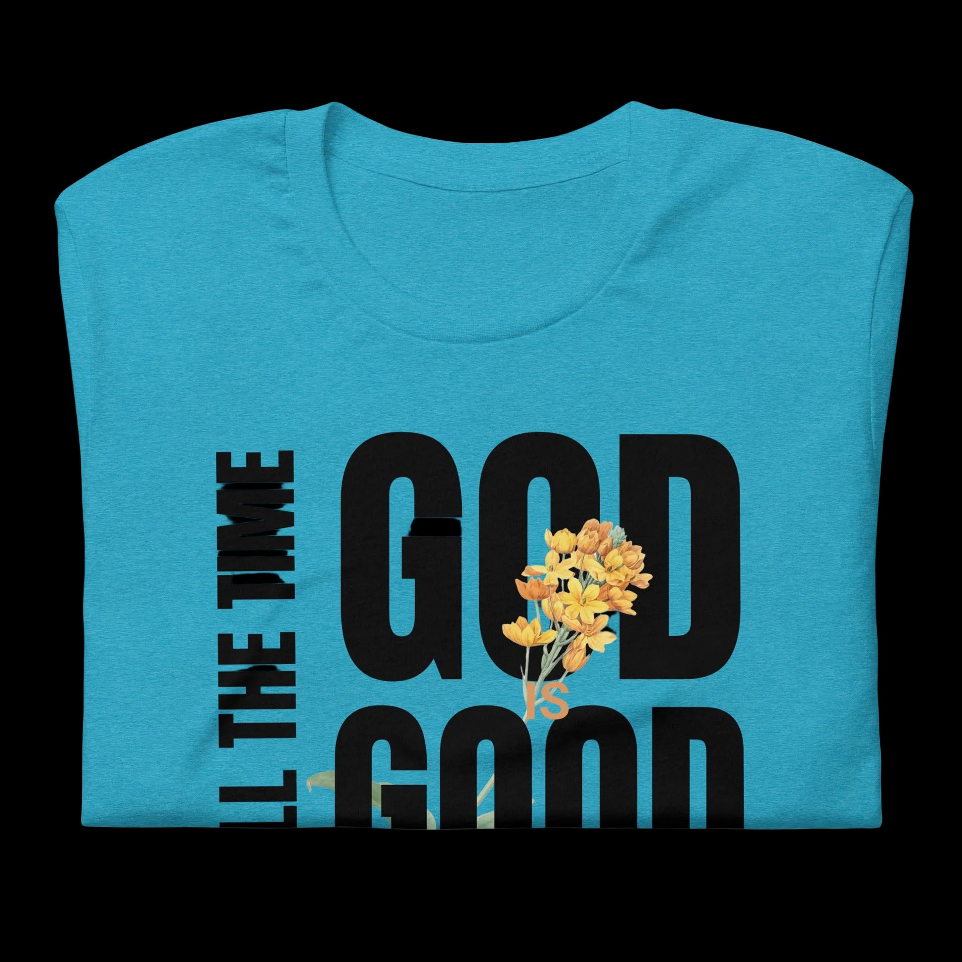 Folded blue t-shirt with," God is good, All the time" text and yellow flowers on a white background