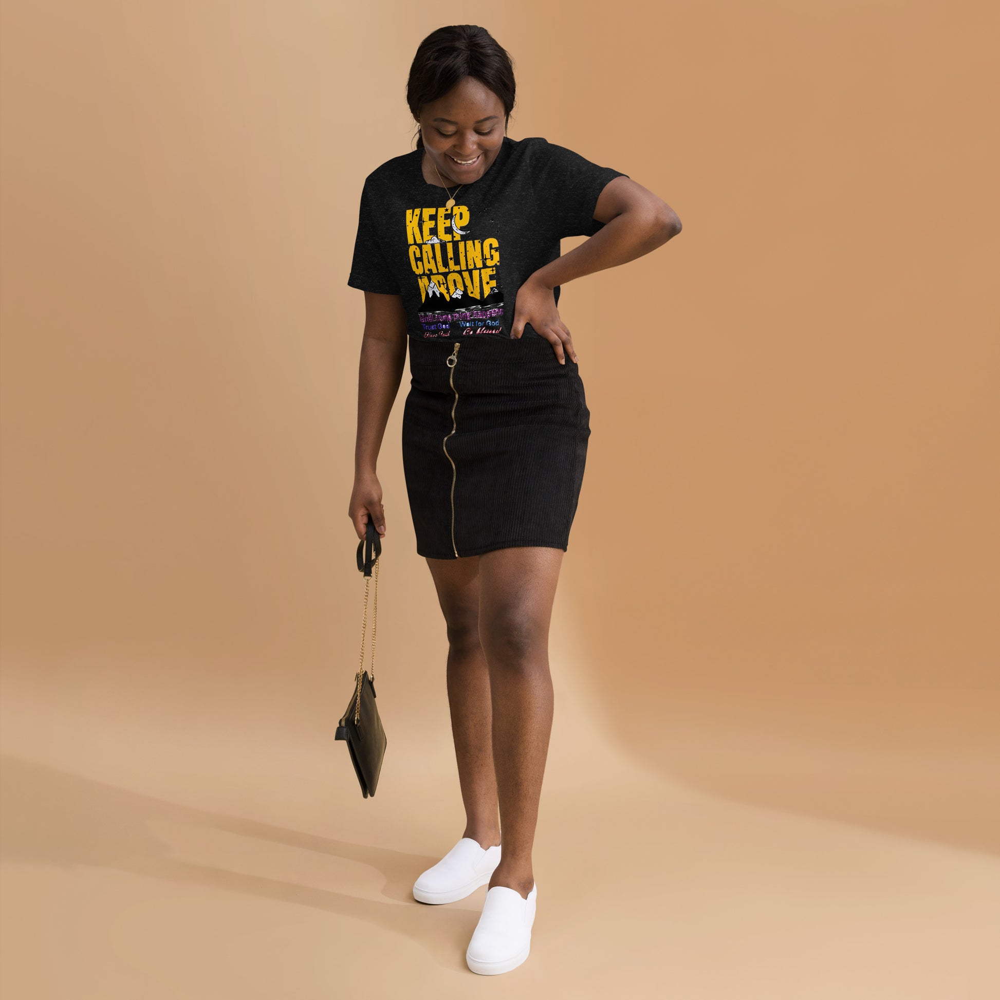 Woman wearing a black t-shirt with a graphic design on unisex T-shirt with “Keep Calling Above – Trust God, Wait for God, Have Faith” inspirational design by Dial Above